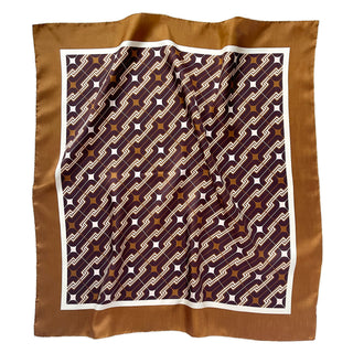 70s-style silk scarf with geometric burgundy and amber pattern featuring chain links and stars, bordered by white trim and amber-taupe edges