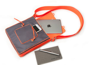 a grey preppy style small messenger bag with orange strap