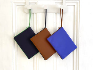 recycled kindle case in three different colors: navy blue, indigo blue and brown