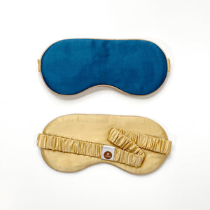 a professionally designed and handmade blue silk eye mask featuring light gold elastic strap and back side 